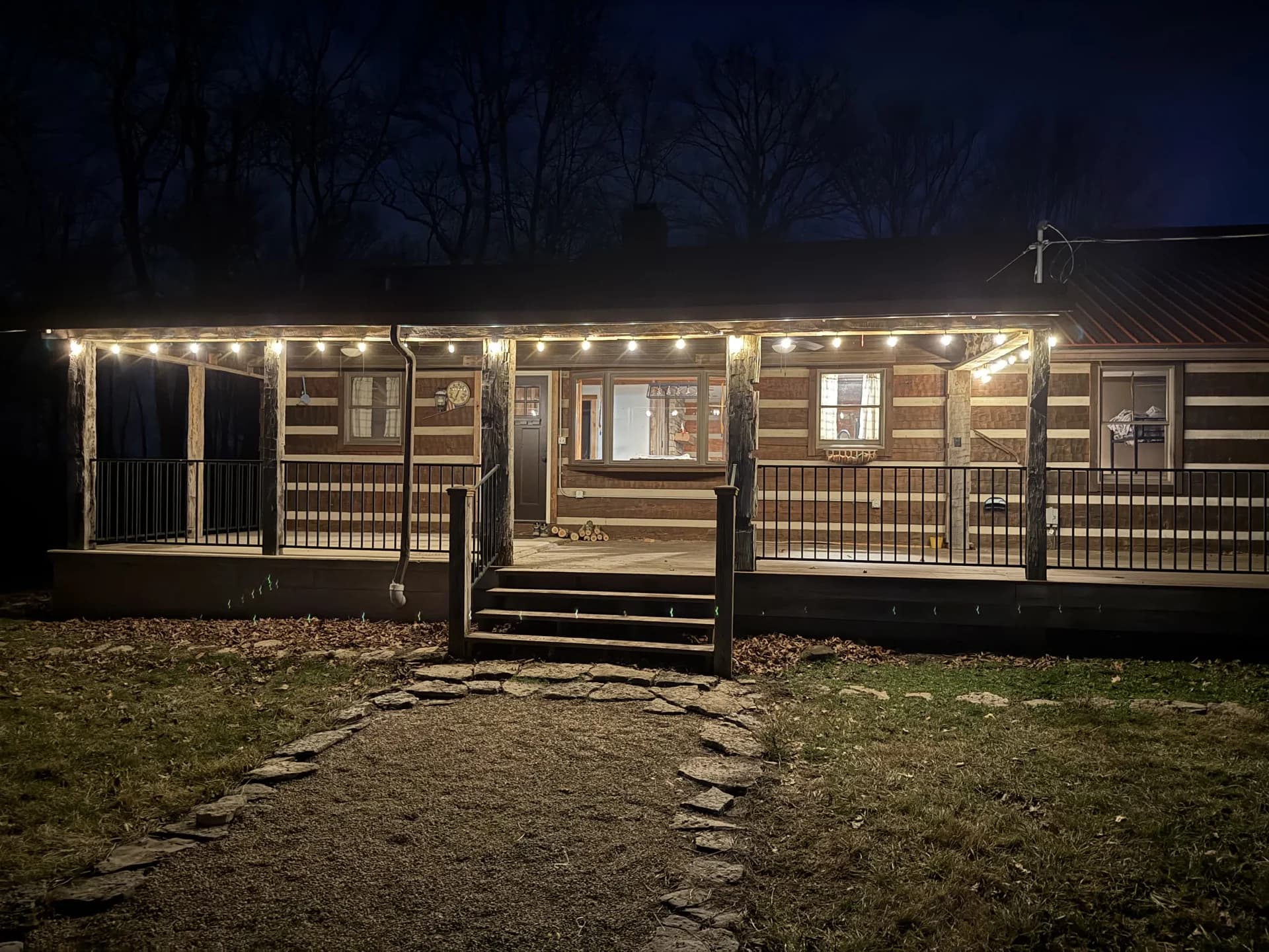 Log cabin porch illuminated at night
